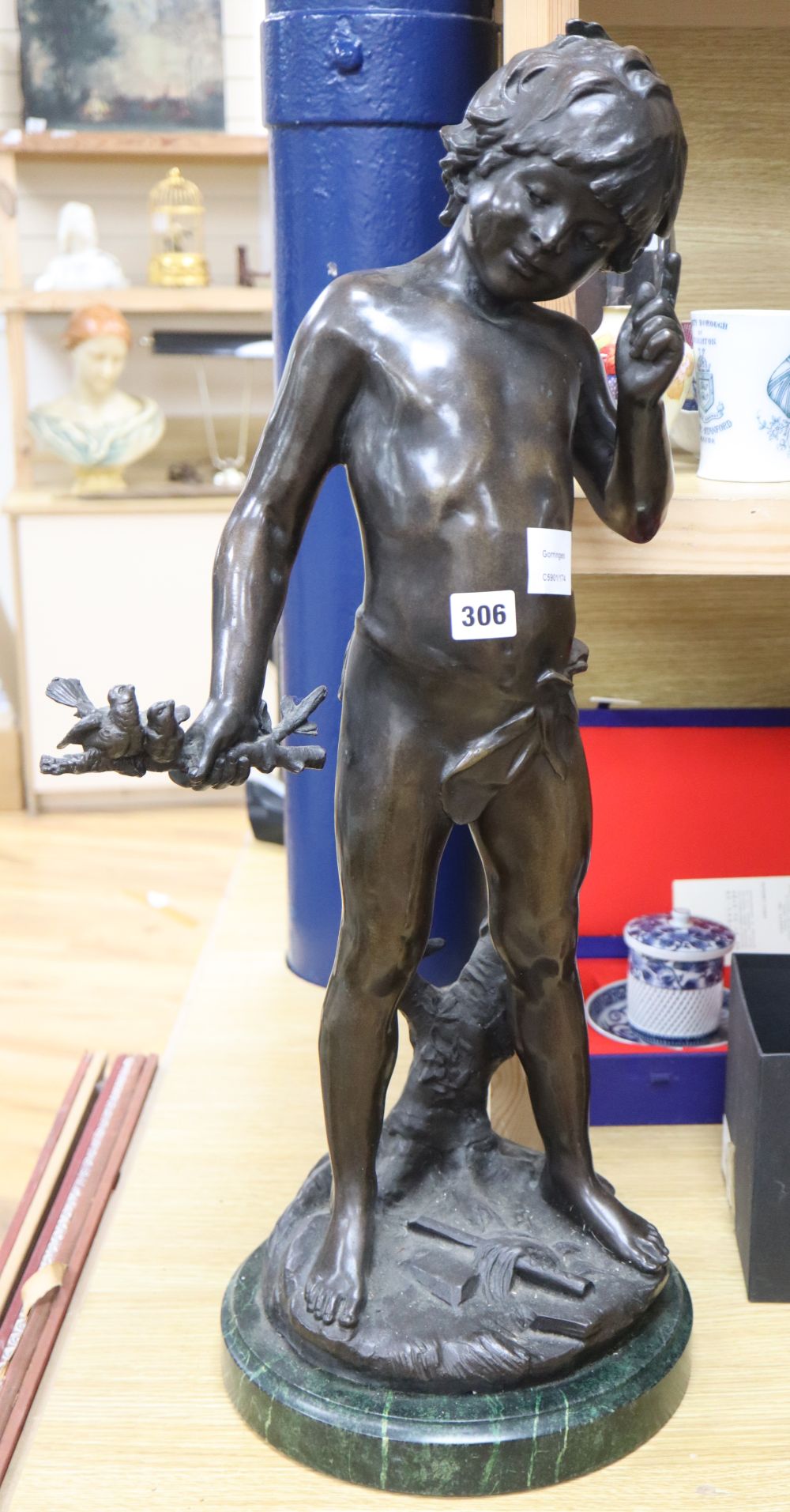 A bronze of a boy holding a stick with bird, height 71cm